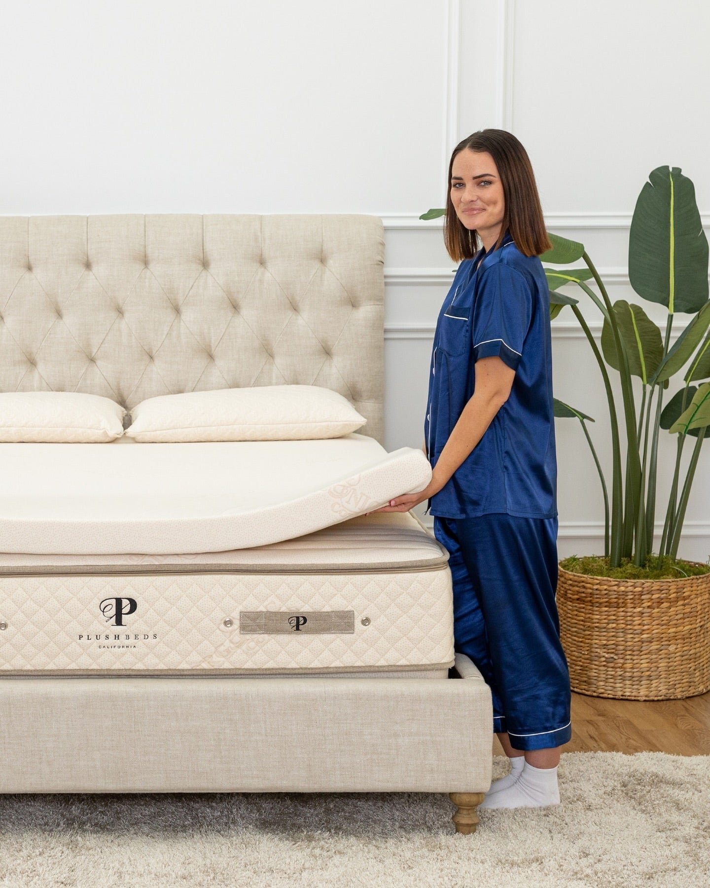 woman placing latex mattress topper